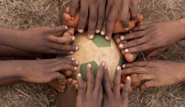 top-view-childs-feet-around-football-ball